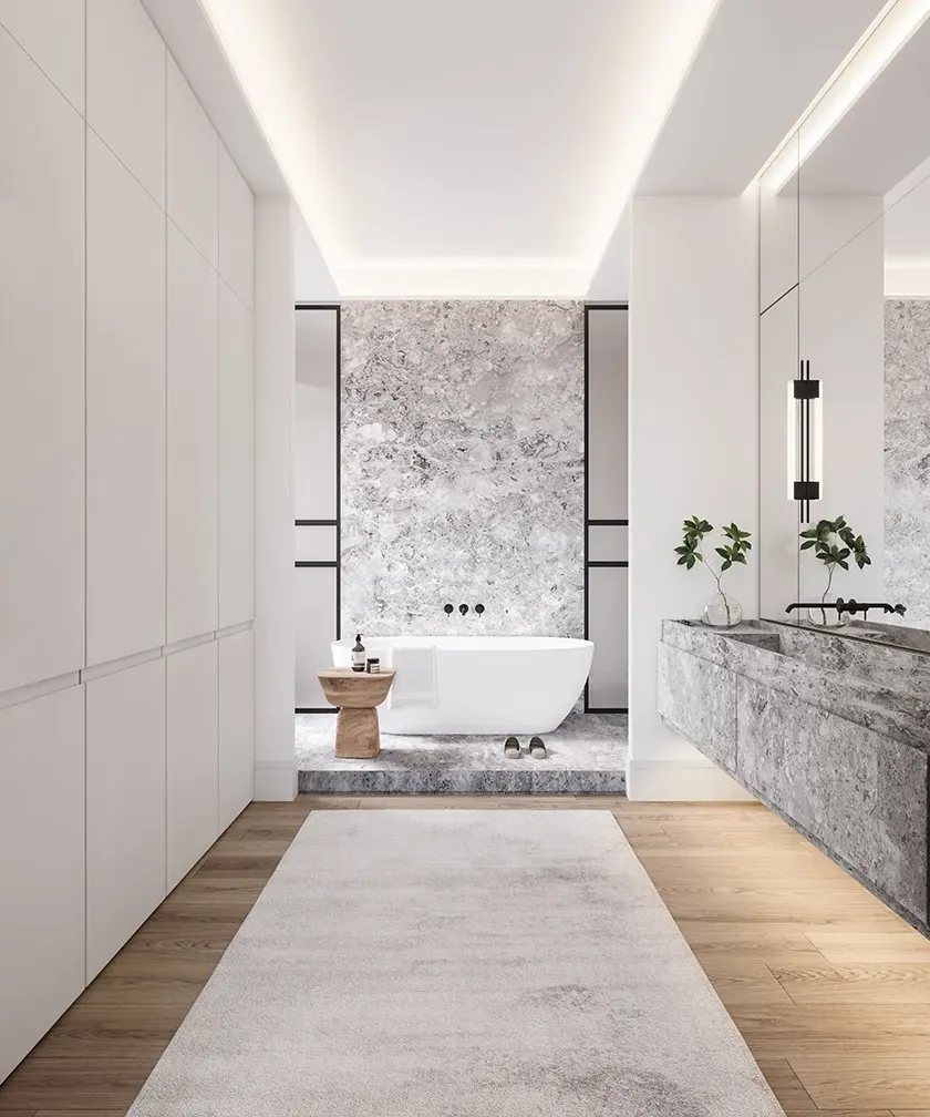 Serene bathroom suite with a sculptural freestanding tub, grey stone finishes, and clean white cabinetry creating a tranquil and balanced aesthetic.