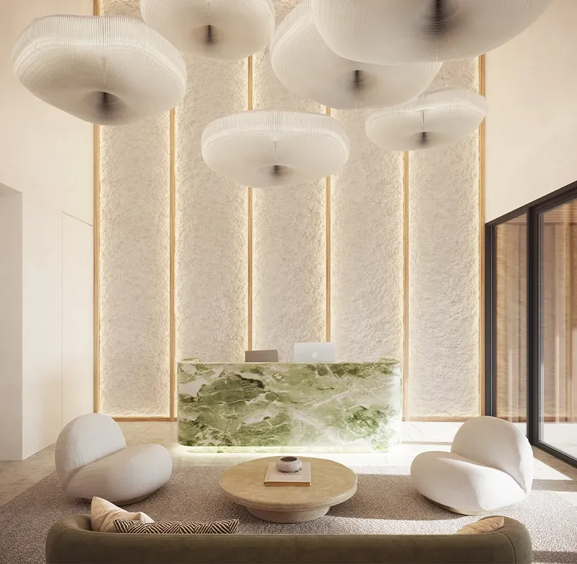 Refined reception area with green onyx desk, sculptural lighting and textured vertical wall panels.
