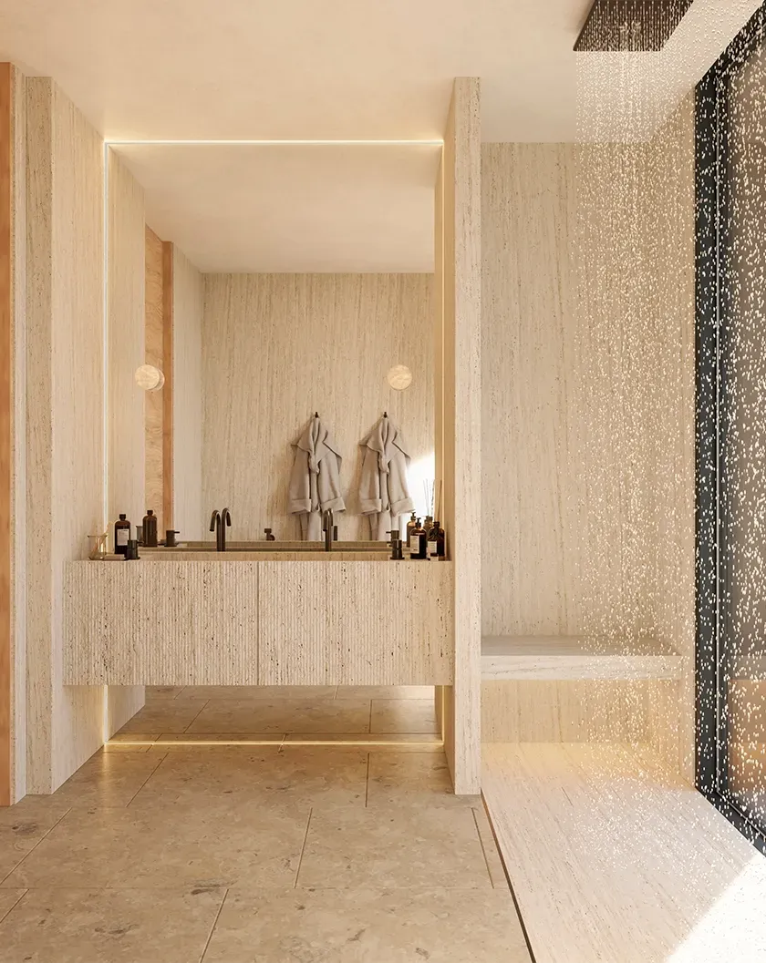 Luxury travertine bathroom interior with rain shower, twin sinks and natural light, designed by LUV Studio.