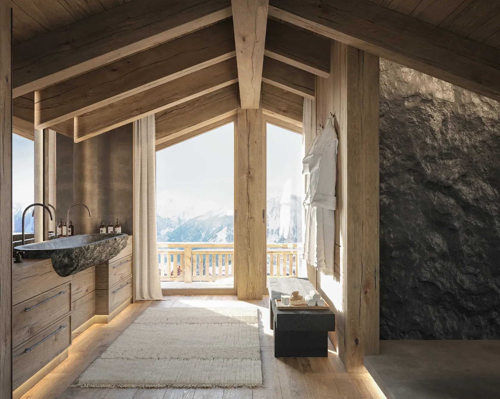 Elegant mountain bathroom with stone sink, natural wood elements, and large windows overlooking snowy peaks.