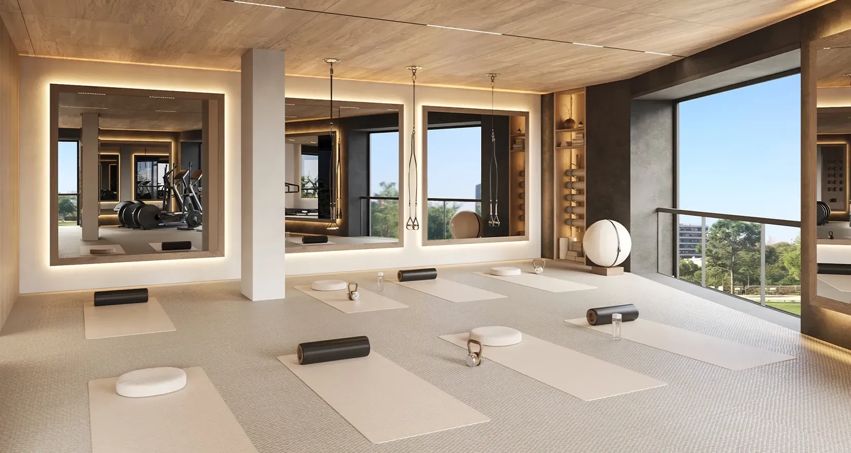 Bright yoga and pilates studio with floor-to-ceiling windows, natural wood accents, and minimalist decor for a calming fitness environment.