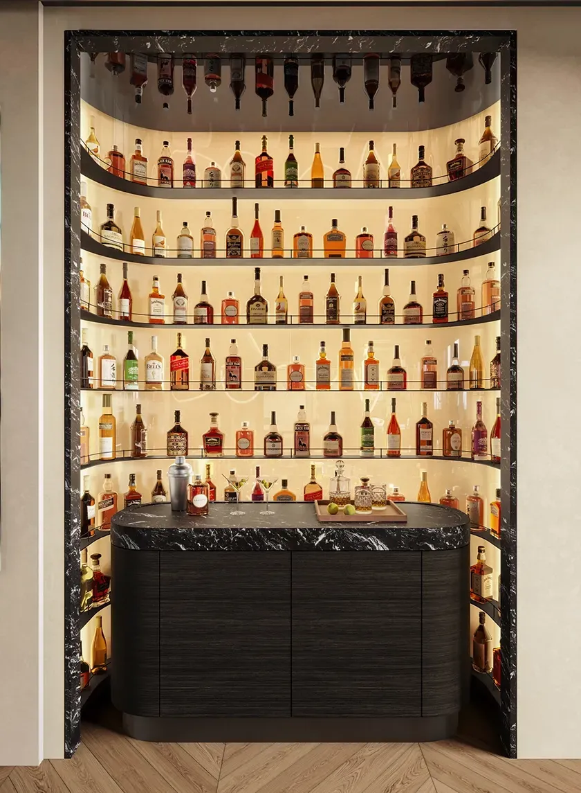 Hidden backlit liquor bar with curved black marble counter in the LUV Studio Andorra office.