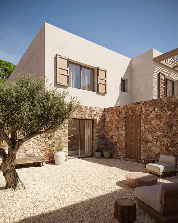 Mediterranean courtyard with olive tree, stone walls and outdoor lounge in contemporary Cala Comte villa