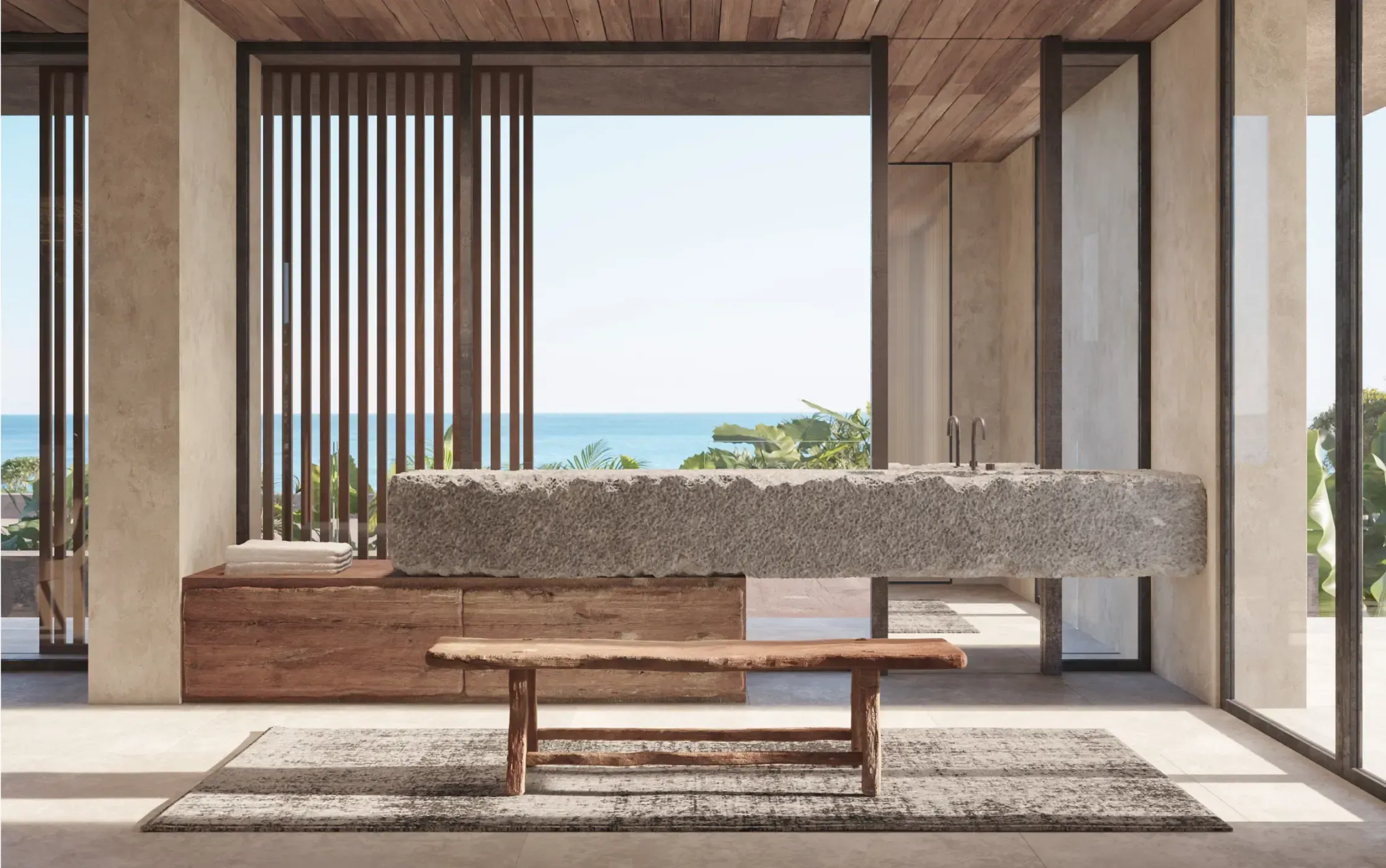 Spa-like bathroom with a floating stone sink, wooden ceiling, and panoramic ocean view framed by minimalist architectural lines.